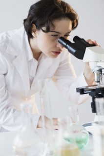 Scientist looking through microscope.
Photo : Jamie Grill