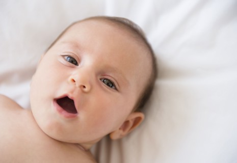 Baby girl (2-5 months) lying on bed.
Photo : Jamie Grill