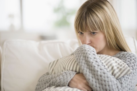 Woman sitting on sofa and thinking.
Photo : Jamie Grill