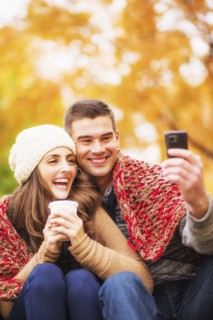 Portrait of couple in Central Park taking photo of themselves. USA, New York State, New York City