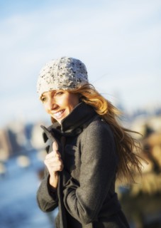 Portrait of cheerful woman in overcoat in autumn. USA, New York City, Brooklyn, Williamsburg