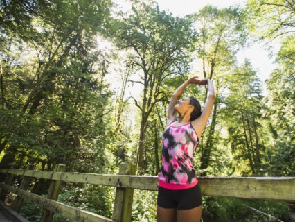 Portrait of young woman stretching on footbridge. USA, Oregon, Portland.