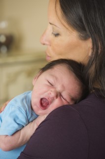 Portrait of mother holding newborn baby (0-11 months).