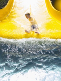 Boy (6-7) having fun on water slide. Germany, Thuringia.
Photo : JOHANNES KROEMER
