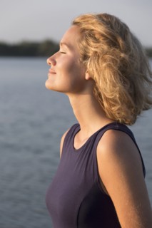 Beautiful woman with closed eyes standing in lake. Netherlands, Gelderland, De Rijkerswoerdse