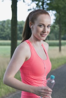Portrait of woman holding bottle of water. The Netherlands, Erp.
Photo : Mark de Leeuw