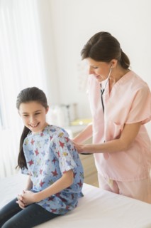 Doctor examining girl (8-9).
