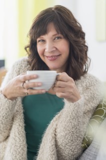 Portrait of woman holding hot drink.