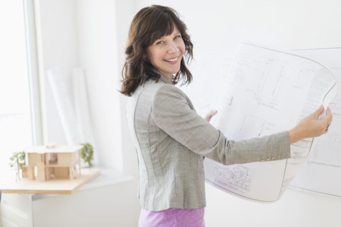 Female architect holding blueprints.