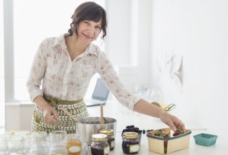 Woman making preserves in kitchen.