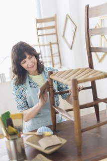 Woman restoring antique furniture.