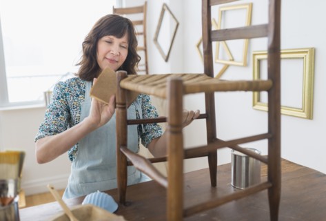 Woman restoring antique furniture.