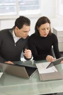 Businessman and businesswoman working in office.