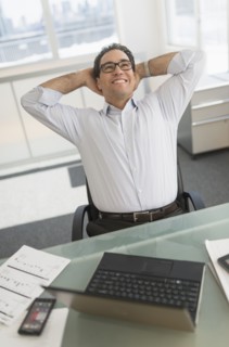 Businessman using laptop and digital tablet.