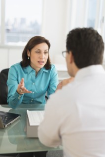 Businessman and businesswoman discussing in office.