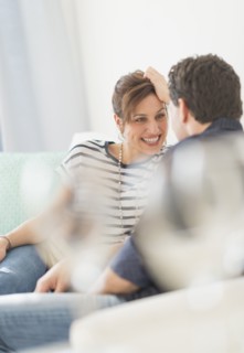 Couple sitting on sofa.