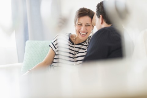 Couple sitting on sofa.