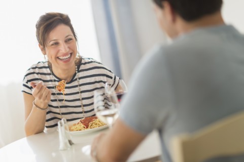 Couple eating spaghetti.