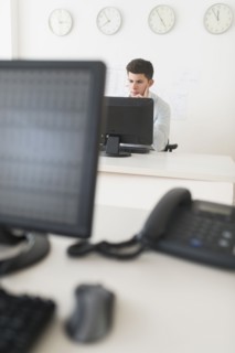 Young man sitting in front of desk and working.