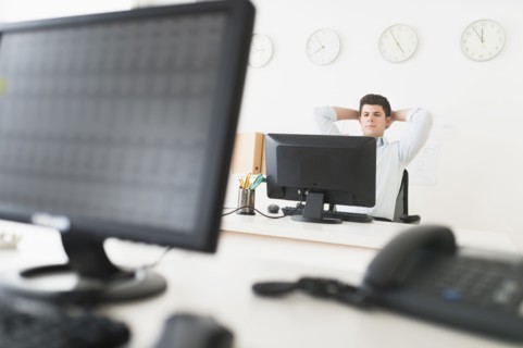 Young man sitting in front of desk and working.