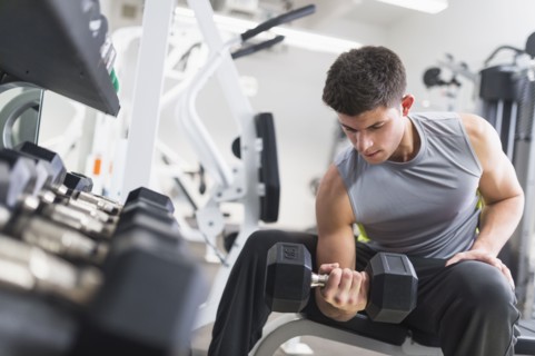 Young man working out at gym.