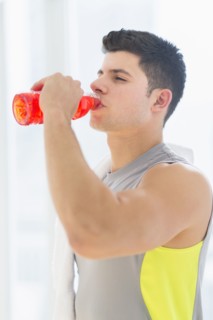 Young man drinking sports drink.
