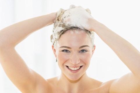 Beautiful woman washing hair.