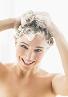 Beautiful woman washing hair.