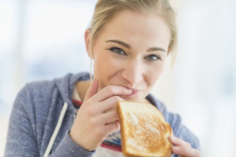 Woman eating toast.