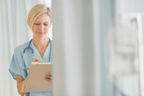 Female doctor doing notes.
