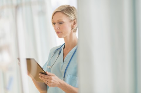 Female doctor using tablet PC.