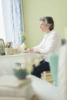 Mature woman writing letter.