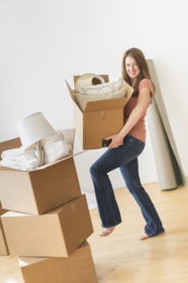 Portrait of woman moving in to new house.