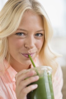 Portrait of young woman drinking smoothie.
Photo : Jamie Grill