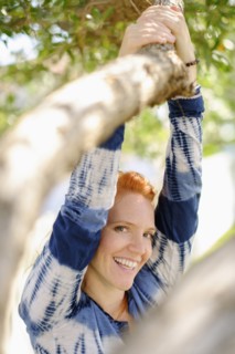 Portrait of woman holding branch.