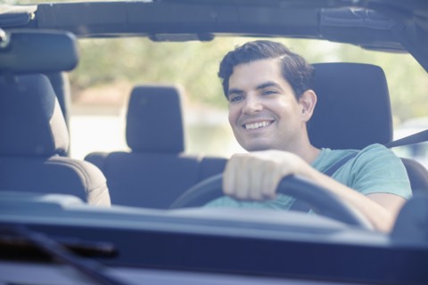 View of man driving car.