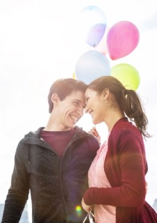 Young couple with balloons.