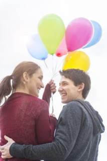 Young couple with balloons.