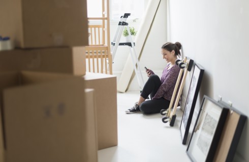 Young woman moving into new flat.