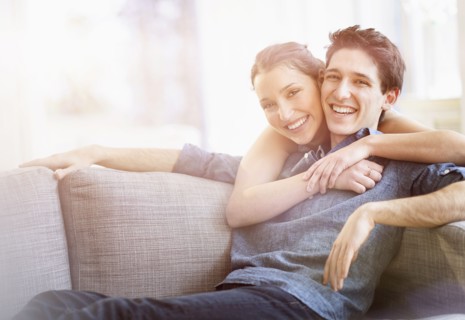 Woman embracing man at home.