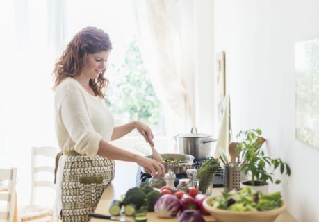 Woman cooking in kitchen.