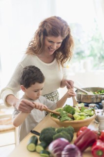 Mother and son (6-7) cooking together.