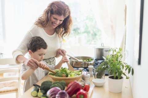 Mother and son (6-7) cooking together.