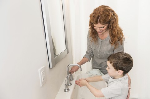 son (6-7) and mother washing hands.