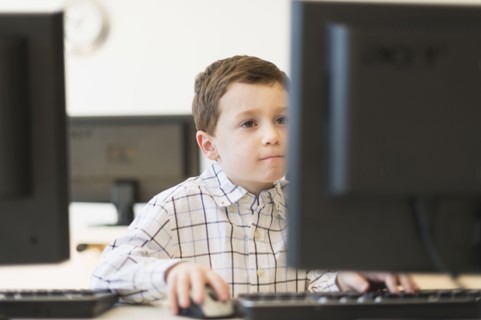 boy (6-7) using computer.