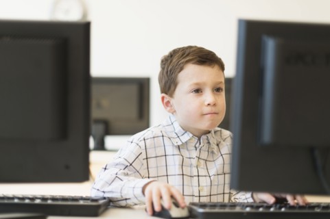 boy (6-7) using computer.