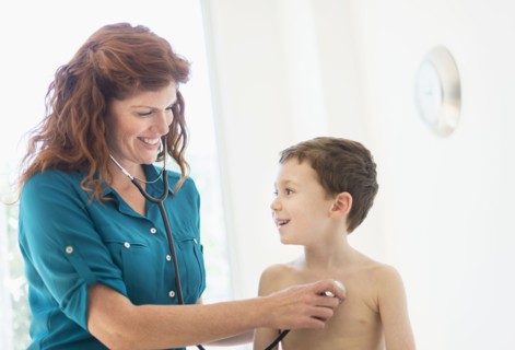 boy (6-7) undergoing medical exam.