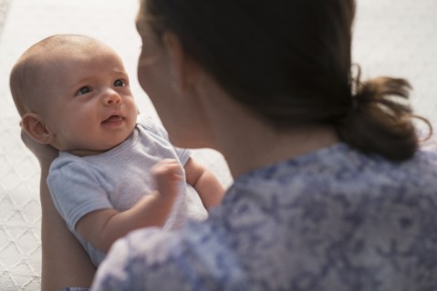 Mother holding baby boy (2-5 months).