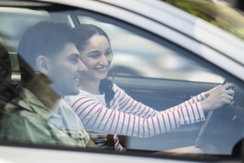 Young couple traveling in car.