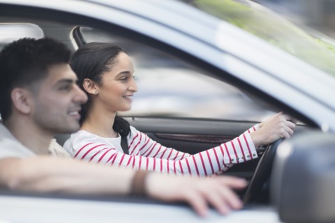 Young couple traveling in car.